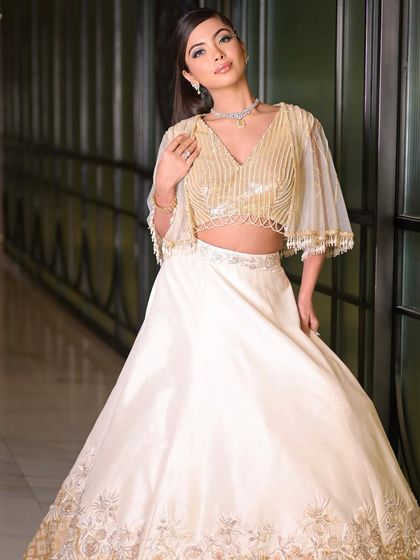 Dancing into the night with this elegant cocktail look. The combination of a shimmering gold and ivory outfit with soft, glamorous makeup is perfect for any celebration.