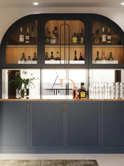 For those who love to entertain, a bespoke home bar can be a stunning centerpiece. This custom-designed unit features an arched glass display, fluted cabinetry, and integrated lighting to create the perfect mood for any occasion. It's a statement of style and hospitality.