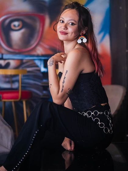 A guest posing against the graffiti wall.