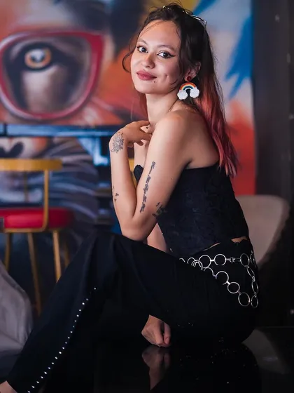 A guest posing against the graffiti wall.