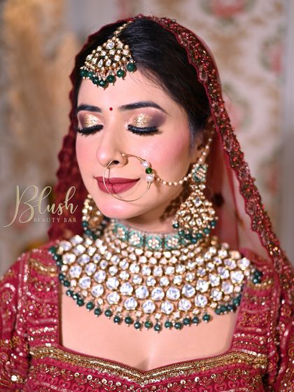 Student work. A classic red and gold bridal look with a bold red lip and golden glitter eyes. My students learn to master these timeless looks.