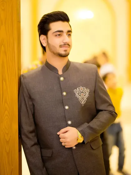 A groom in a grey Jodhpuri suit with silver embroidery. This is a unique and elegant choice for a reception or engagement.