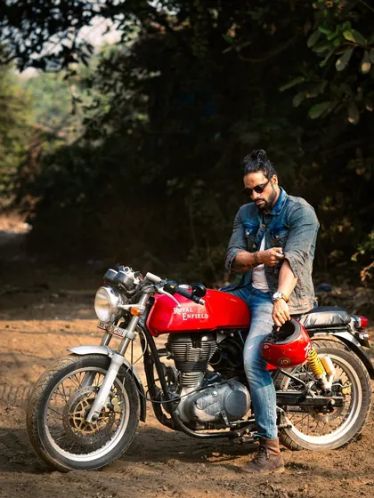 A relaxed pose with the motorcycle, capturing the cool, easy-going vibe of a rider.
