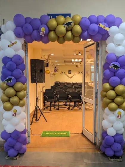 A balloon arch creates a welcoming entrance for any event. This one, for a college function, uses the event's color scheme and themed cutouts to set the tone from the moment guests arrive.