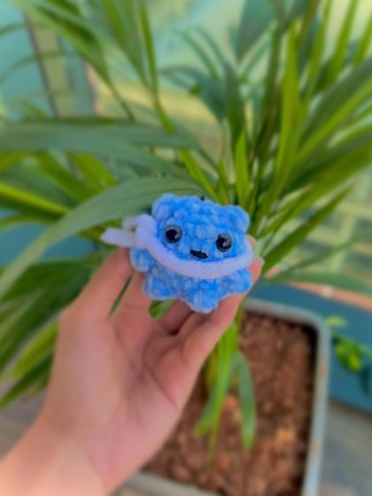 A slightly different angle of the blue Winter Bear keychain, highlighting its soft, plush texture. It's small enough to fit in your palm but big enough to be a cute companion.
