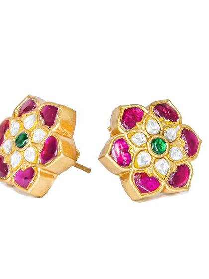 These beautiful floral studs are crafted with gold plating over silver, featuring pink Kundan petals and a green center stone. They are perfect for festive occasions.