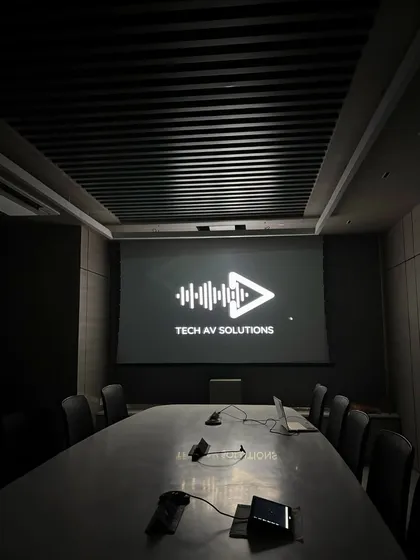 A clean, professional finish in a corporate boardroom after our installation. The screen is ready for a high-impact presentation, reflecting our commitment to seamless and reliable AV solutions for businesses.