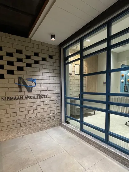 The exterior entrance to our studio, featuring our logo on a modern brick wall with unique perforated details. The design reflects our architectural approach of blending textures and forms.