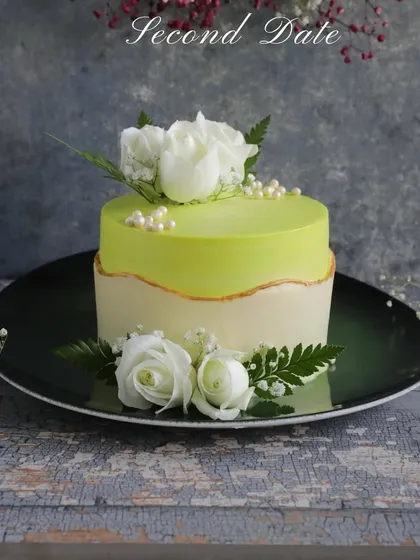 Perfect for a second date or a special anniversary. This stunning cake with a lime green glaze and fresh white roses is designed to make a memorable impression.
