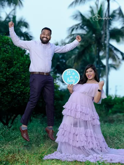 A fun and joyful gender reveal photo. The father-to-be jumps for joy as they announce they are having a boy.
