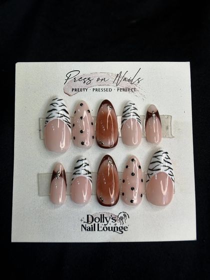 A trendy mixed-pattern press-on set, combining zebra print, polka dots, and a glossy brown accent nail.