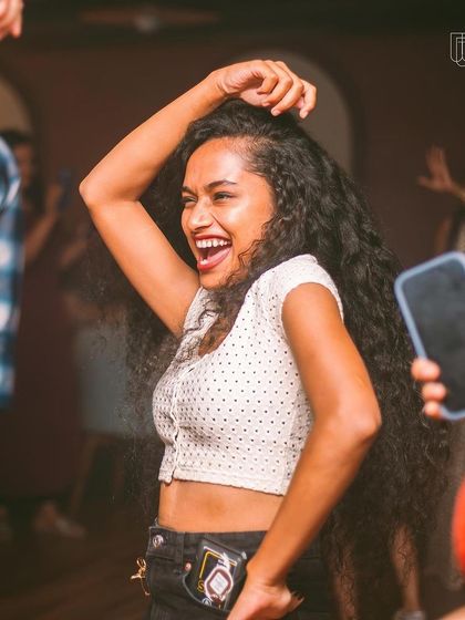A guest with beautiful long hair, dancing and having a great time.