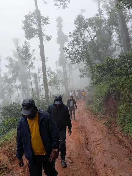 Walking along a muddy path through a foggy forest. This is what a true monsoon adventure looks like.