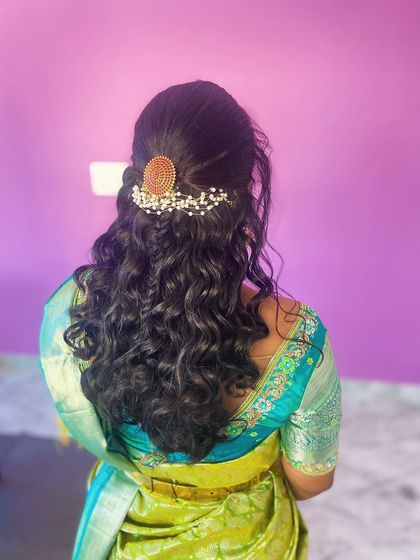 A back view of the half-up curly hairstyle.