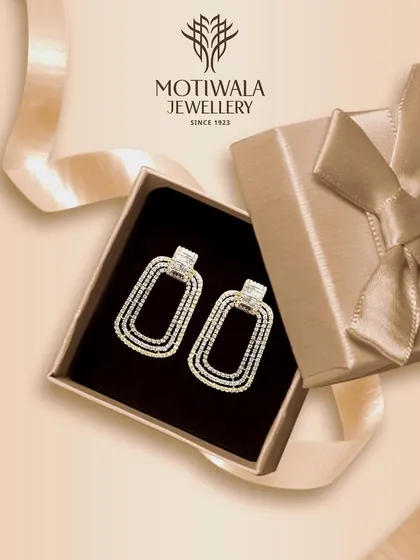 A pair of modern, rectangular diamond earrings presented in a gift box, making them the perfect present for a loved one.