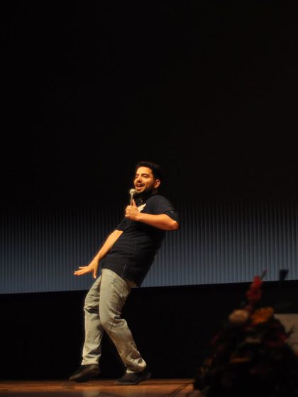 Samay Raina's energetic physical comedy captured mid-motion during his performance.
