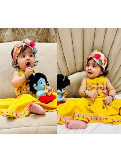Our little Radha Rani celebrating Janmashtami. She looks absolutely adorable in our yellow ethnic dress with a colorful floral headband, holding her little Krishna doll.