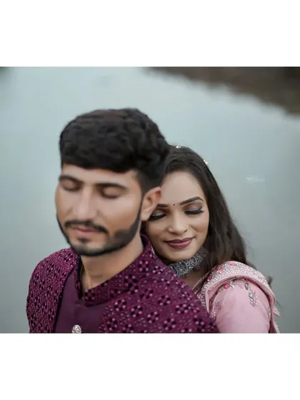 A serene and intimate close-up of the couple. The soft focus and natural setting by the water create a very peaceful and romantic atmosphere.