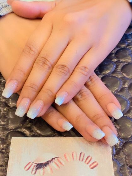 A subtle and shimmery baby boomer ombre on short, square nails. The white tips have a pearlescent finish, giving them a beautiful, subtle glow.