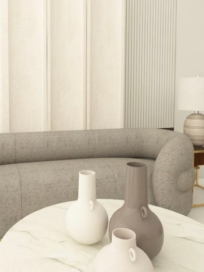 A close-up of the decor on the marble coffee table. Small details and curated decor pieces are essential to complete the look of a room.