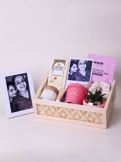 The complete sister birthday hamper, featuring a framed photo, chocolates, and a variety of self-care products in a woven wooden box.