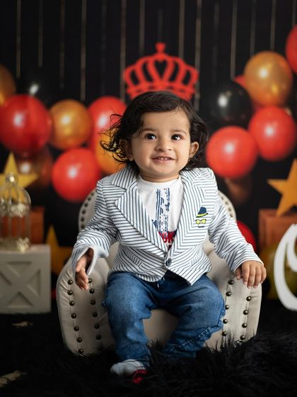 A happy smile from the birthday king. We work to make your baby comfortable so we can capture their best expressions.