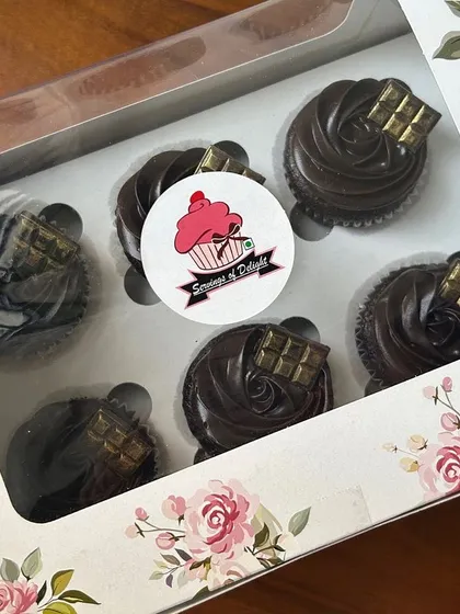 A classic choice that never disappoints. This is a box of 6 of my signature double chocolate cupcakes, each topped with a rich ganache swirl and a small piece of chocolate.