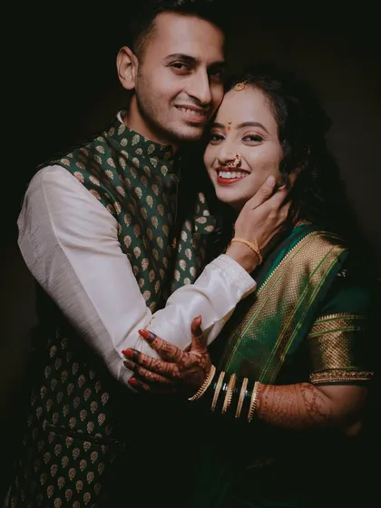A joyful portrait from an engagement shoot. The bride's arm around the groom and their bright smiles create a warm, happy image that perfectly captures their excitement.