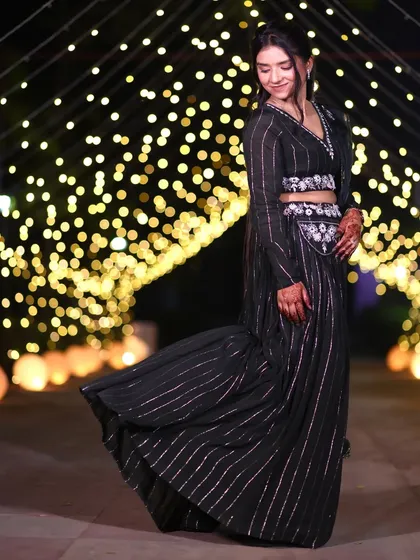 A simple and subtle party look. The hair is styled in a half-up ponytail, which is a trendy and youthful choice for an evening event.