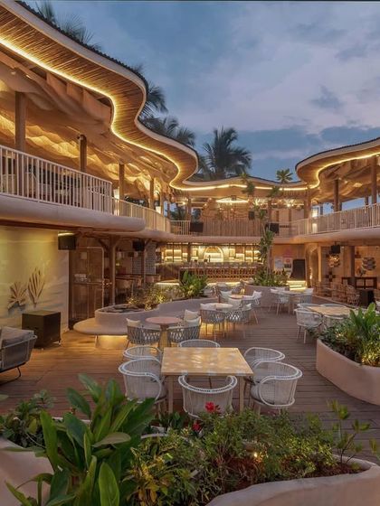 The evening view at Dubki, where the architectural lighting traces the curves of the building. The entire space was designed to come alive at night, creating a vibrant social hub on the Goa coast.