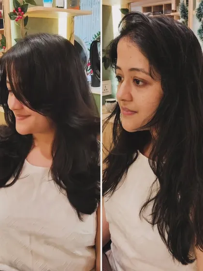 A classic before-and-after of a haircut. The new layered style adds volume and shape, completely transforming her look from simple to sophisticated.