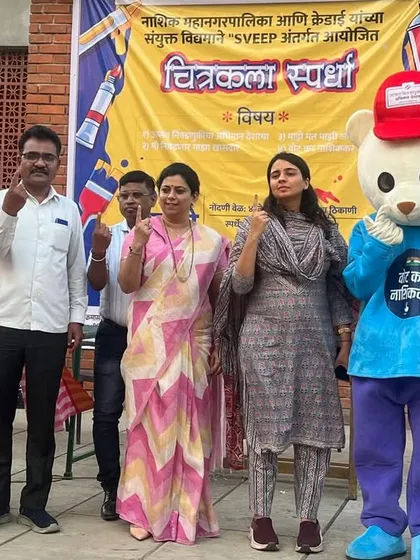 Posing with officials and the event mascot, all showing our inked fingers to promote voter participation. Art can be a powerful tool for spreading important social messages.