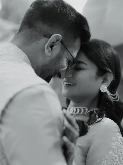 A close-up black and white shot of the couple, their faces close together, sharing a quiet, happy moment. This image is incredibly intimate and full of emotion.