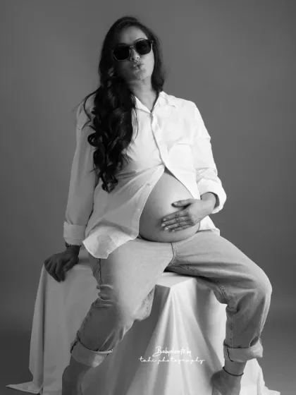 Cool, confident, and unapologetically stylish. This black and white portrait with sunglasses and an open shirt has a relaxed, editorial feel, perfect for the modern mother.