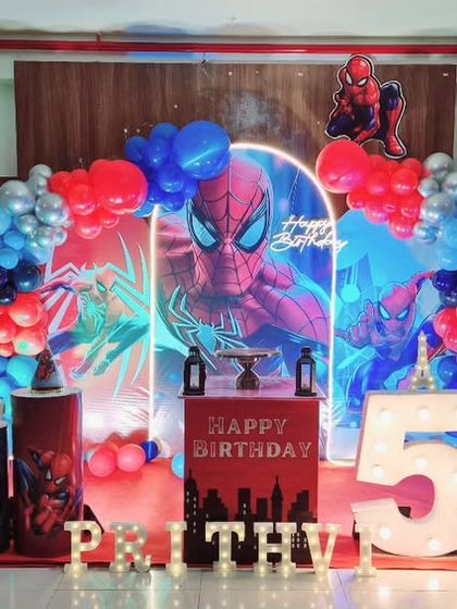 A 3D-style Spiderman themed birthday party with a layered backdrop and neon lighting to create depth and excitement.