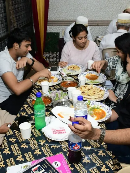 A group of friends enjoying their Iftar meal together.