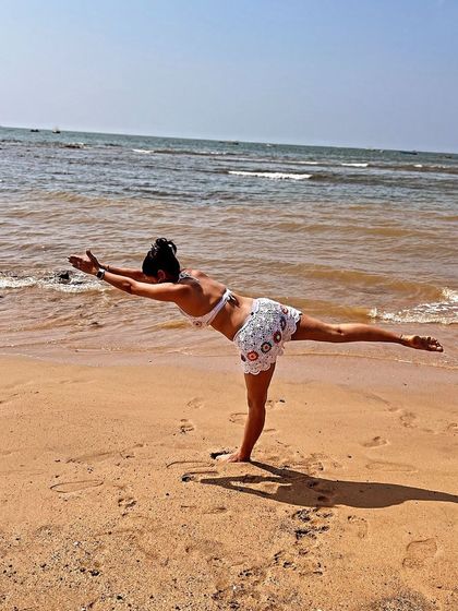 A sunshine state of mind in Warrior III at the water's edge. I find so much joy in my practice, especially with my toes in the sand and the sun on my skin.