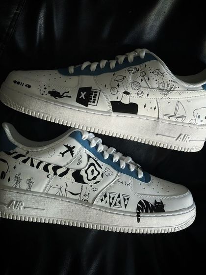 A custom Nike Air Force 1 covered in personal doodles and symbols that tell the client's unique story.