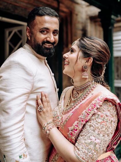 A playful moment between my husband and me. Our coordinated outfits reflect our personal style while staying true to traditional aesthetics.
