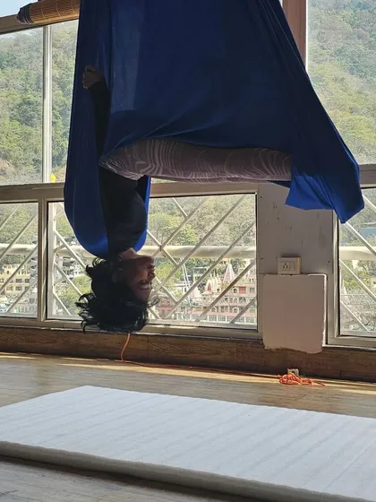 The pure joy of hanging upside down. This simple inversion in the aerial hammock helps to decompress the spine, improve circulation, and bring a smile to your face.