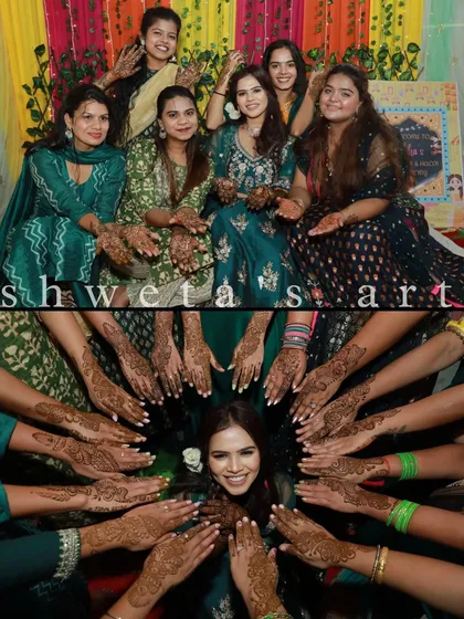 Capturing the happy vibes of a mehendi night. Here is the bride with her entire bride squad, all showing off the beautiful mehendi designs we created for them.