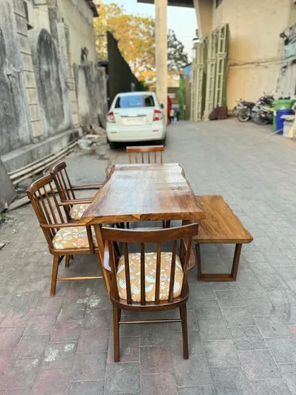 A different view of the rustic live-edge dining table and chairs.