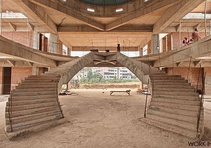 A comparison of the render and the reality of a grand symmetrical staircase in a residential villa. This architectural centerpiece was designed to be a statement of grandeur, with its dual curving form creating a powerful focal point in the entrance lobby.