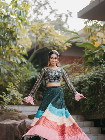 The bride twirling in her fun and colorful carnival lehenga.