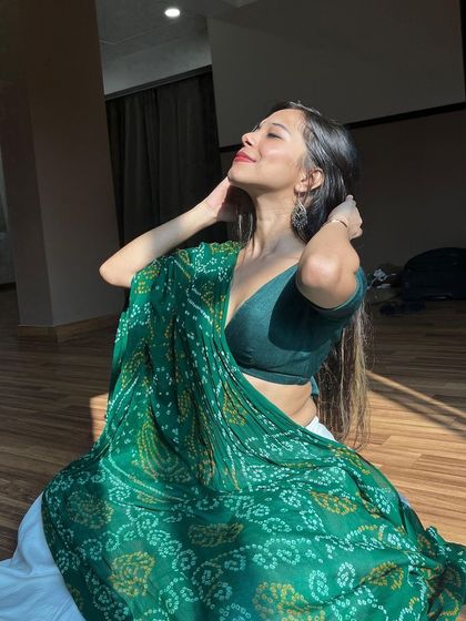 Soaking in the sun, a candid moment of peace and joy while dressed for a traditional performance.