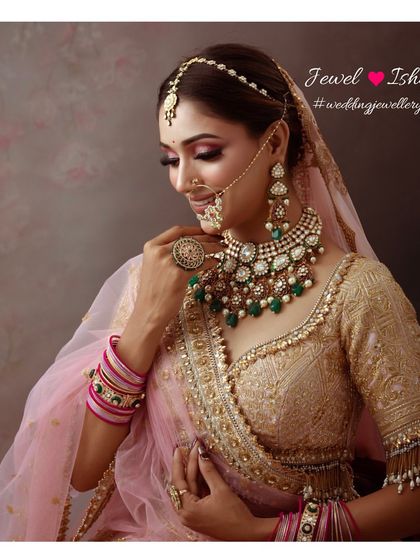 A classic pose showing the side profile, highlighting the intricate details of the choker, the mathapatti, and the large statement ring.