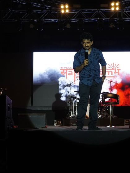 Naveen Richard commanding the stage during the comedy night at IIM Visakhapatnam.