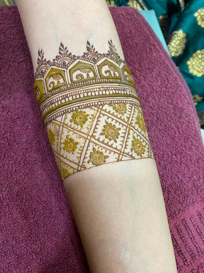 This arm cuff features a parade of tiny elephants, a symbol of good luck and prosperity, requested by the bride.