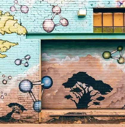 This large-scale exterior mural combines scientific and natural elements, painted across a brick wall and metal shutter. We are equipped to handle complex surfaces and large projects.