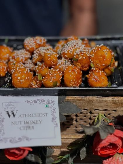 Another look at our Waterchestnut Honey Chili, served on a rustic wooden platter. The presentation is just as important to us as the taste.